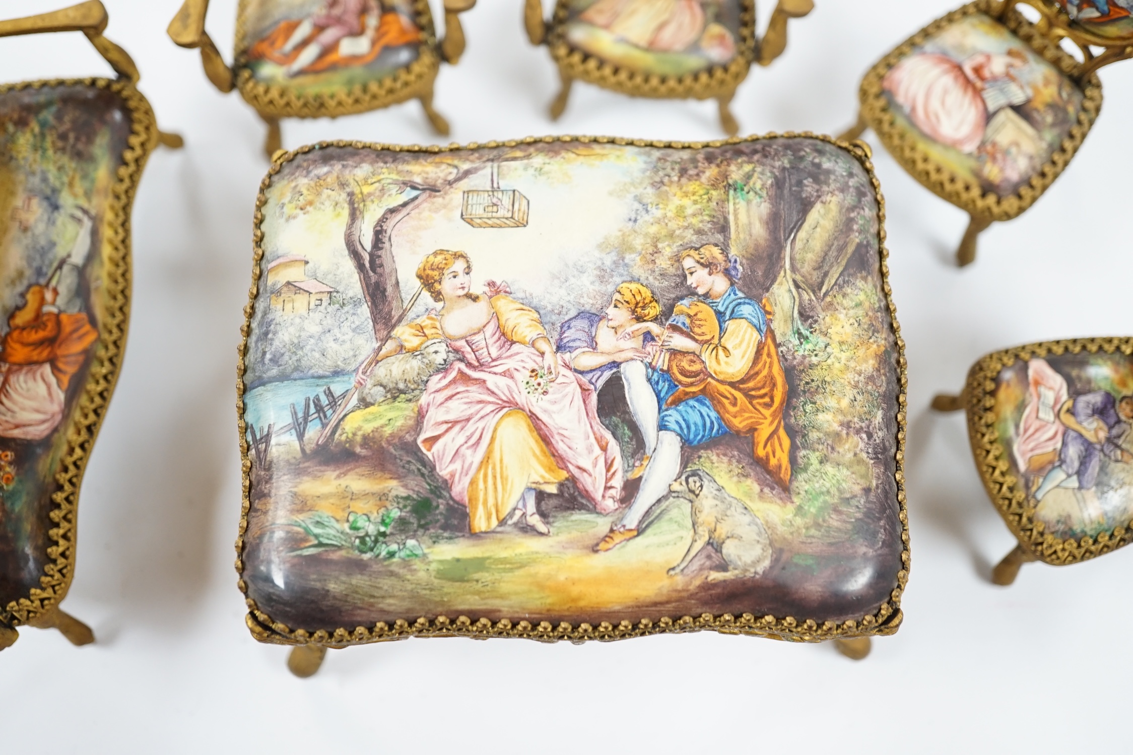An early 20th century miniature enamel and gilt metal framed furniture set, possibly Austrian, largest 9cm wide. Condition - fair